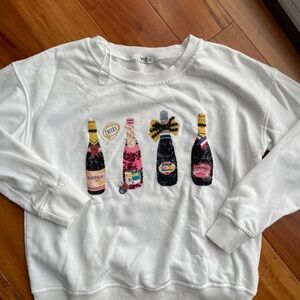 Boutique White Sweatshirt with Sequin Champagne Bottle Design